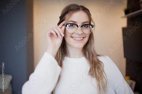 Fototapeta Naklejka Na Ścianę i Meble -  Happy and beautiful girl with glasses and braces. Joyful and surprised face