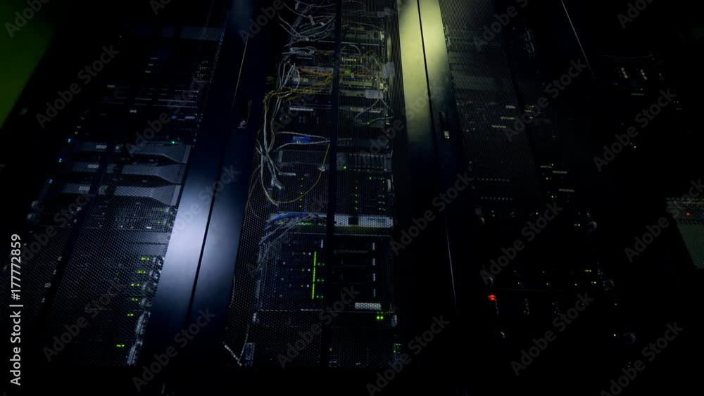 Network servers in a data center. Dark server room. Network servers in a data center. Dark server room.