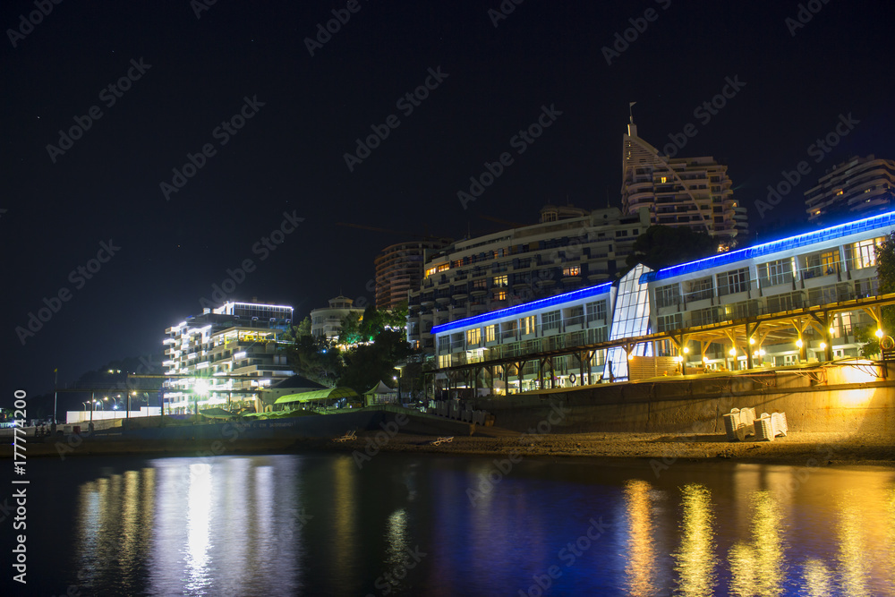 beautiful building on the beach. night landscape, visible reflections in the water
