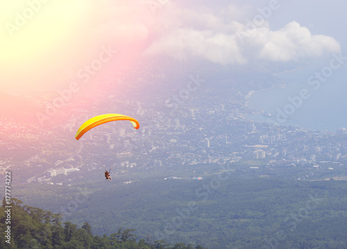 sportsman flies paraglider in the sky. Paragliding sport dangerous