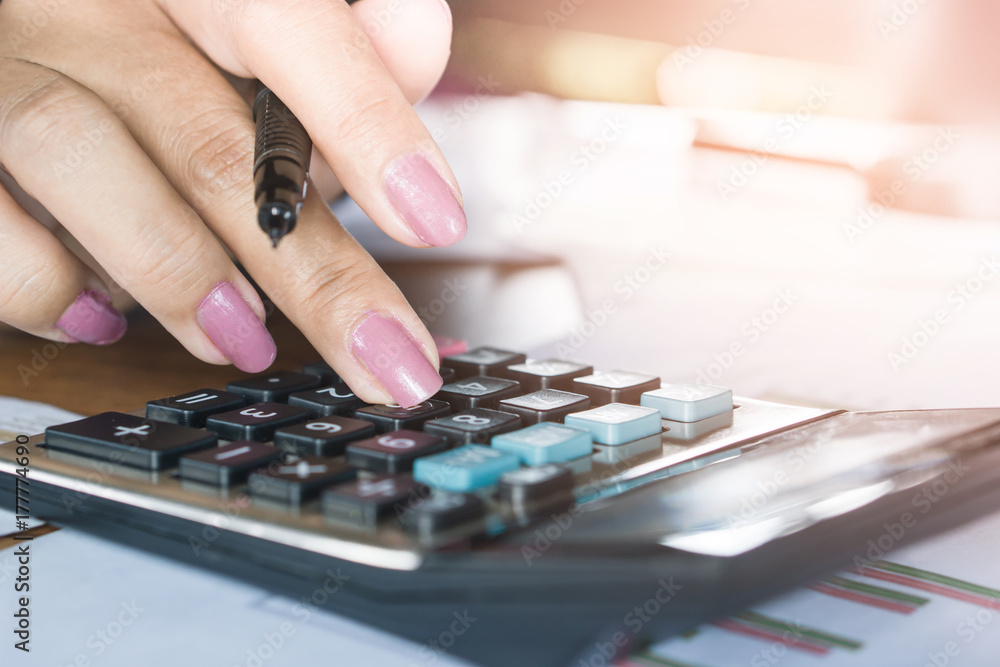 business woman hand counting on calculator for finance ,investment and payment concept background 