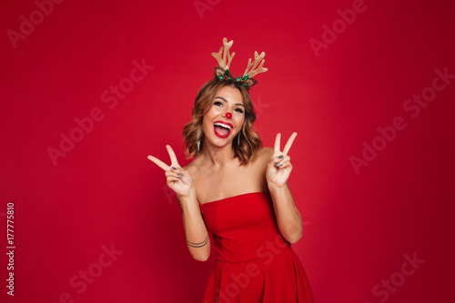 Portrait of a joyful happy girl wearing christmas deer costume