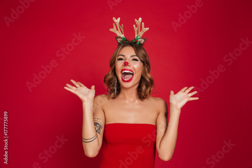Portrait of a joyful amused girl wearing christmas deer costume