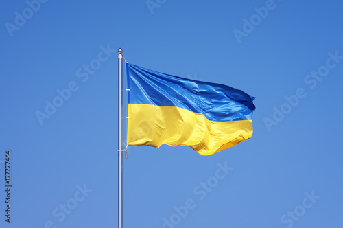 Ukrainian flag on blue sky backgroud © silentgos