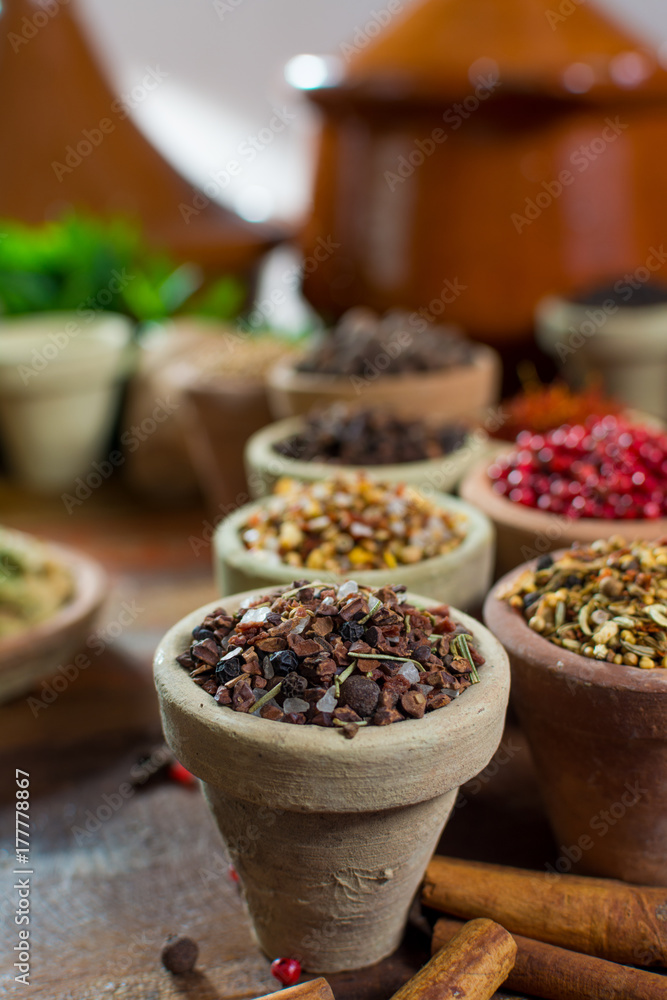 Variety of different asian and middle east spices, colorful assortment, on old wooden table Variety of different asian and middle east spices, colorful assortment, on old wooden table