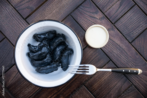 Black Russian dumplings vareniki in bowl photo