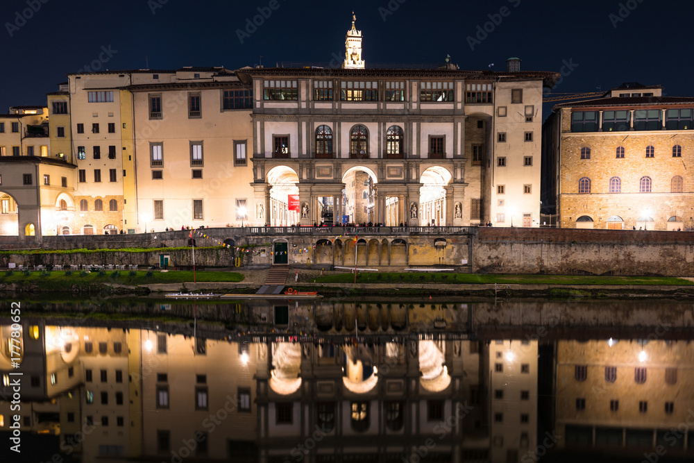 View of the reflected buildings and Florence Rowing Club in the river Arno.