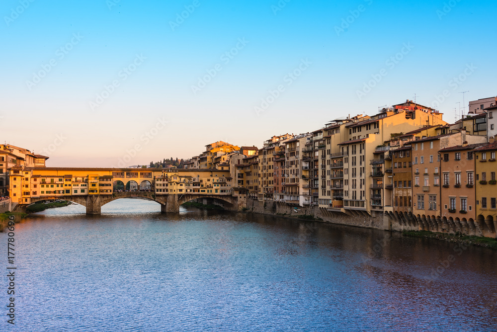The Ponte Vecchio bridge over the Arno River at sunset. The Ponte Vecchio bridge over the Arno River at sunset.