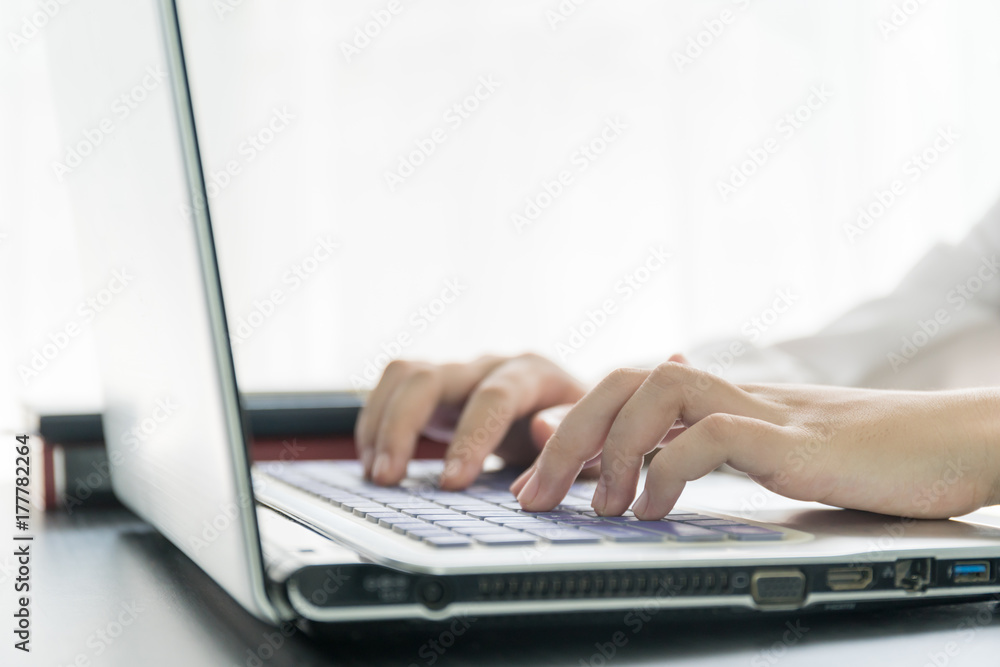 Woman hands typing on laptop keyboard Woman hands typing on laptop keyboard