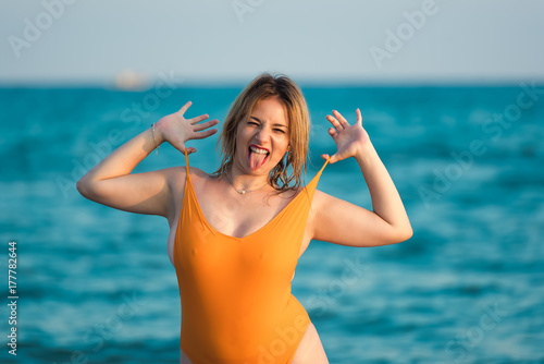 Young woman wear monokini enjoying the sea and the summer photo