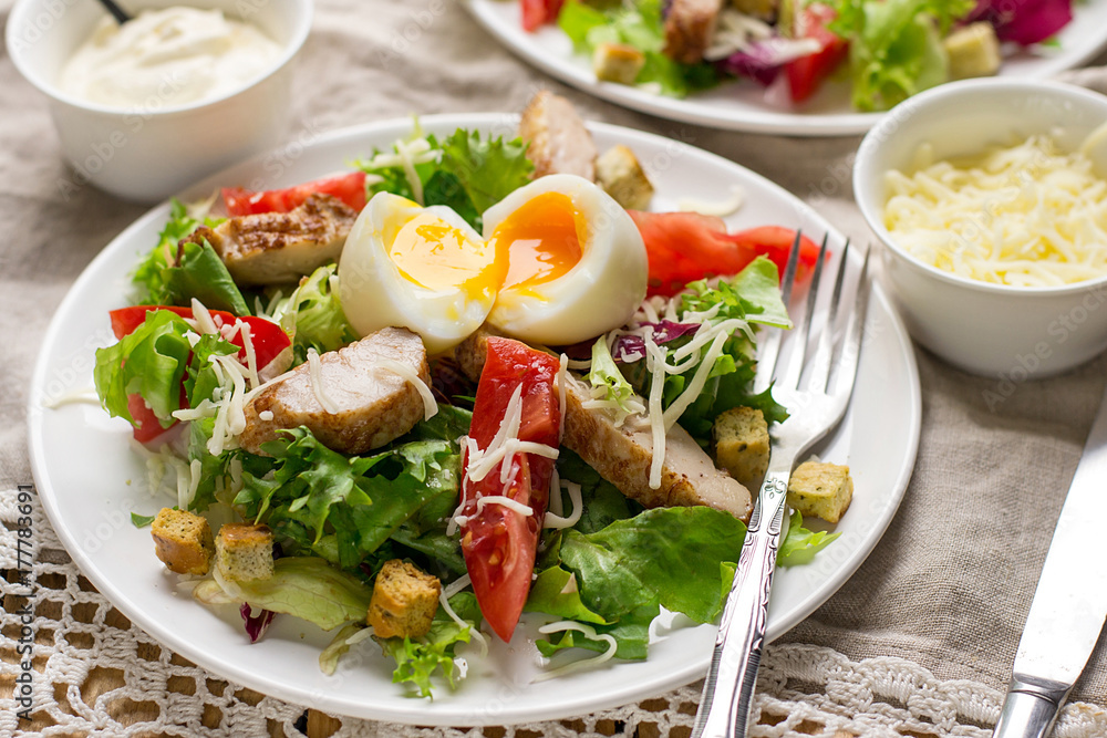 Caesar salad with lettuce, tomato, grilled chicken and cheese Caesar salad with lettuce, tomato, grilled chicken and cheese