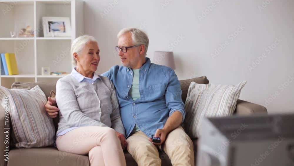happy senior couple watching tv at home happy senior couple watching tv at home