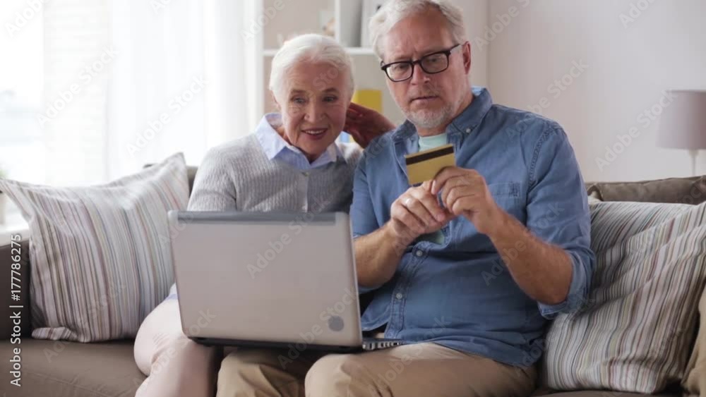 happy senior couple with laptop and credit card happy senior couple with laptop and credit card