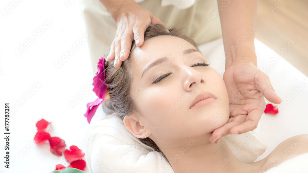beautiful and healthy young woman relaxing with face massage at beauty spa salon beautiful and healthy young woman relaxing with face massage at beauty spa salon