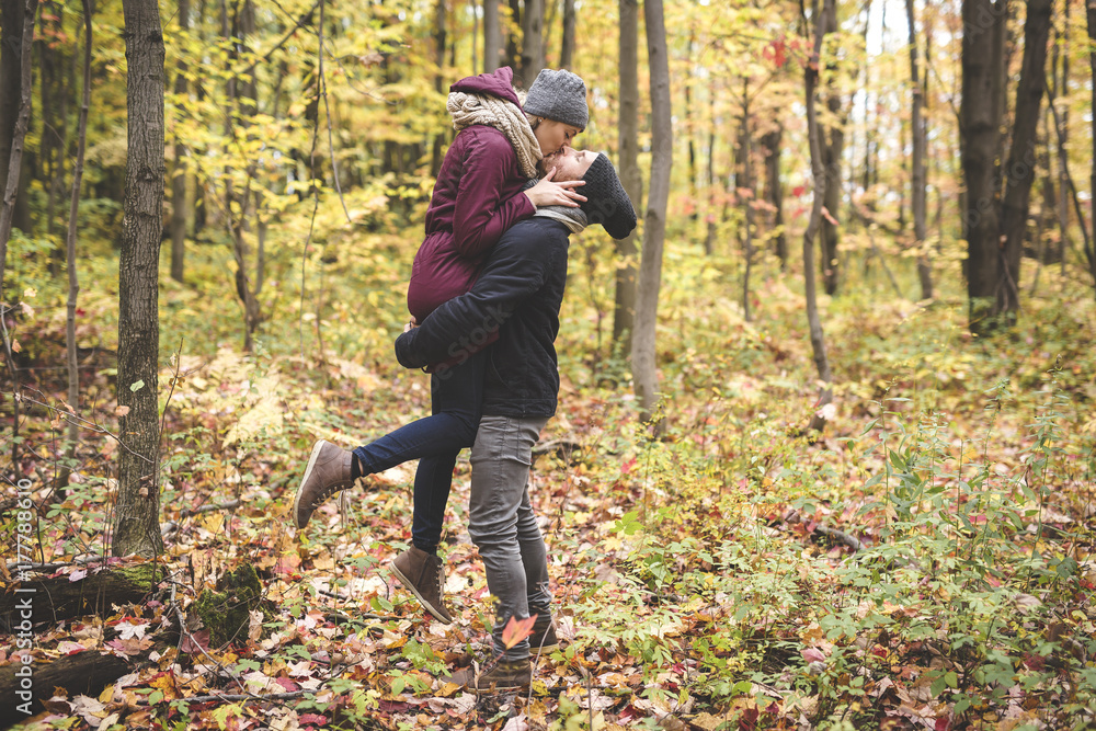 Young couple in love in a park on a autumn day