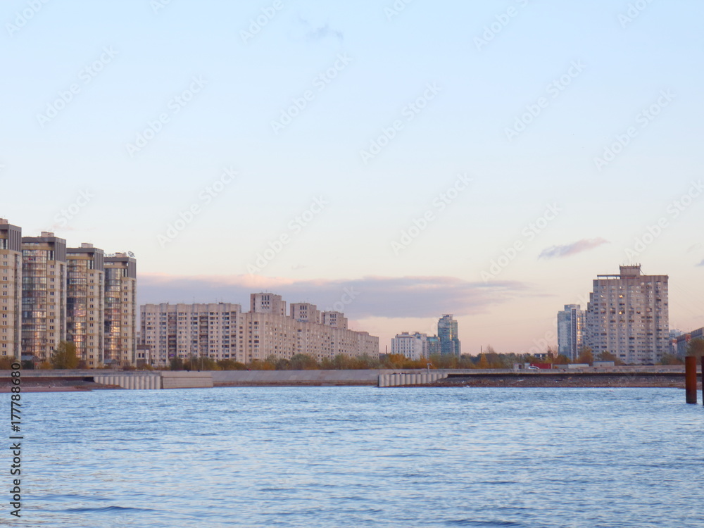 Urban blocks high-rise buildings on the beach at sunset