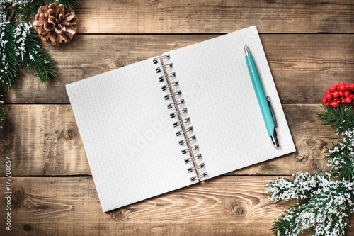 Blank paper notebook on brown wooden table background. Top view with copy space. © alexxndr