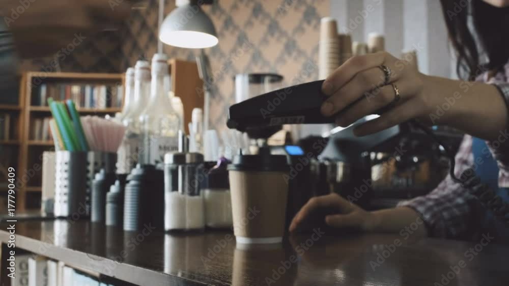 Customer paying NFC with phone at coffee shop Customer paying NFC with phone at coffee shop