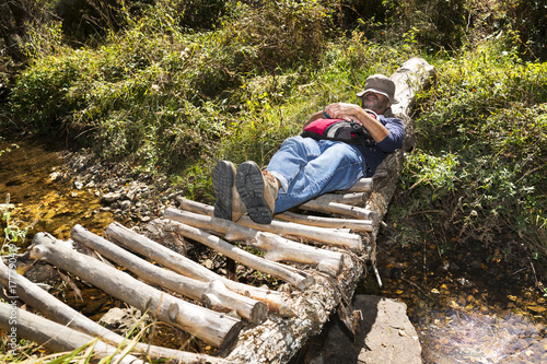 trekking and hiking , man in wooden bridge over river