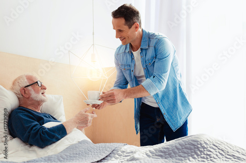 Картината върху платно Delighted young man visiting his grandpa