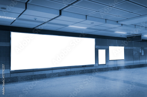 blank advertising billboard or light box with copy space for your text message or media content in subway train station or airport, information board, commercial, marketing concept, blue tone color