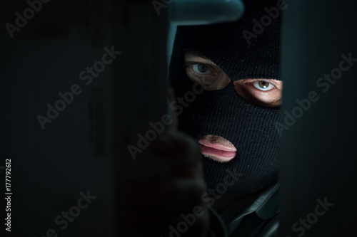 Unrecognizable masked burglar. Close up