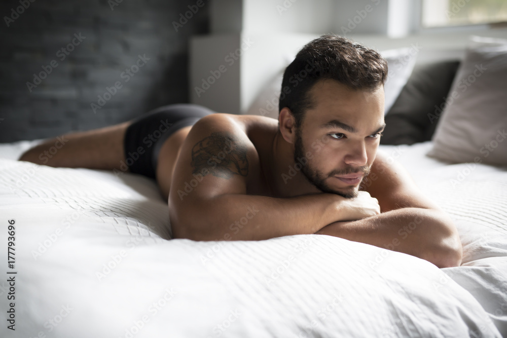 young man shirtless in white bed young man shirtless in white bed