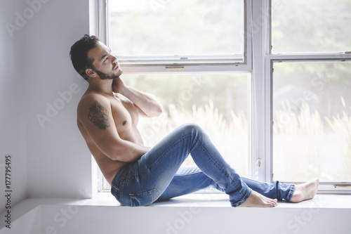 Sexy fashion portrait of a hot male model in stylish jeans with muscular  body Stock Photo | Adobe Stock
