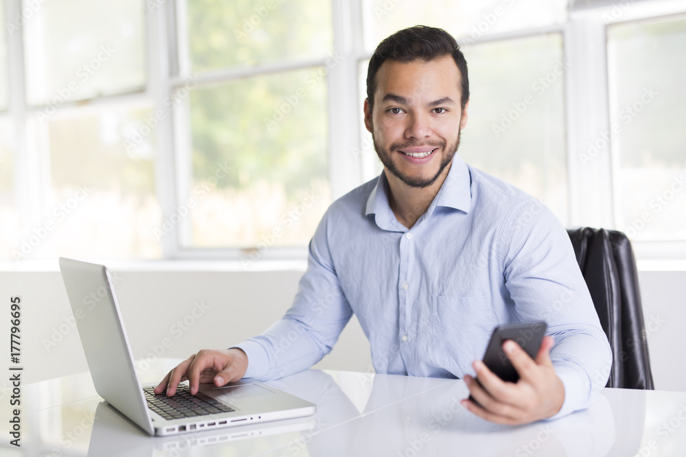 Fototapeta premium mexican attractive businessman on his 30s working at modern home office with computer laptop