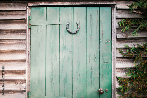 Lucky horseshoe on a wooden shed door