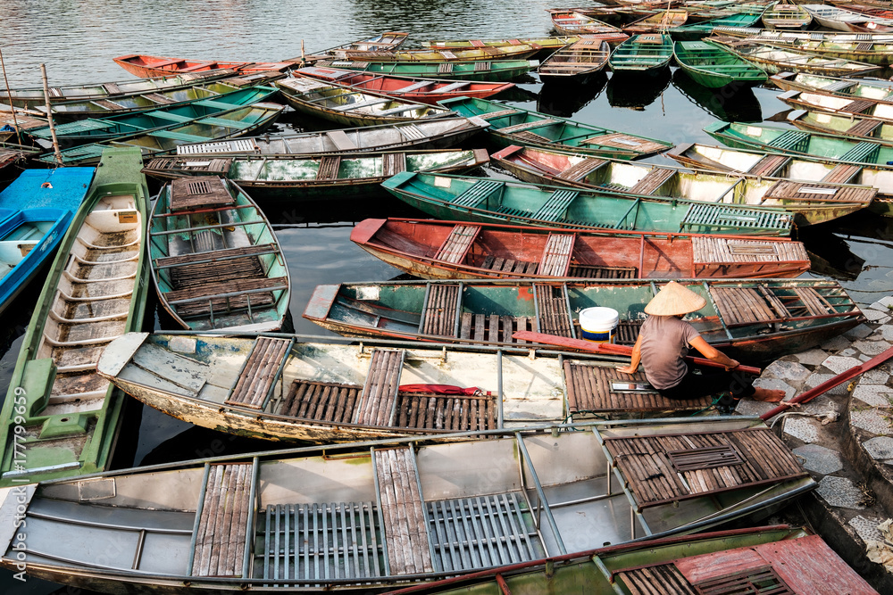 Long-tail boats traditional of northern vietnamese anchored on pier