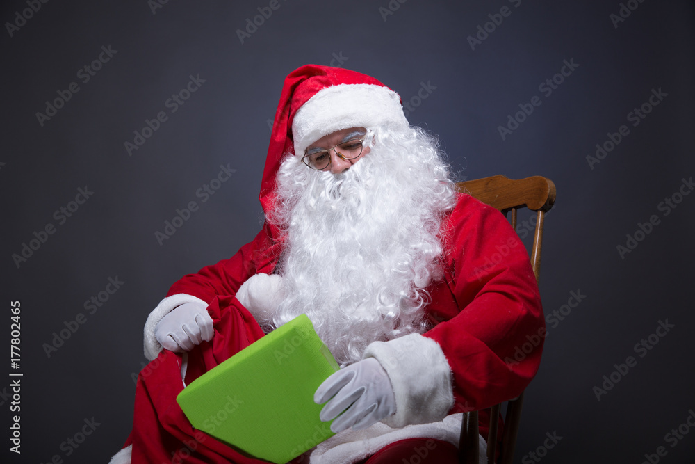 Naklejka premium Santa Claus packet gifts for kids.