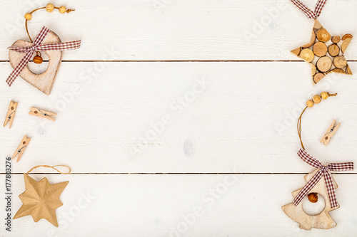 christmas or new year frame composition. rustic cozy christmas decorations on wooden background with empty copy space for text. holiday and celebration concept for postcard or invitation. top view