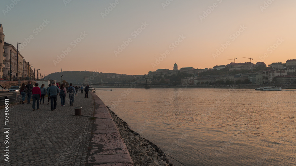 walk in Budapest sightseeing by Danube bank sunset in city