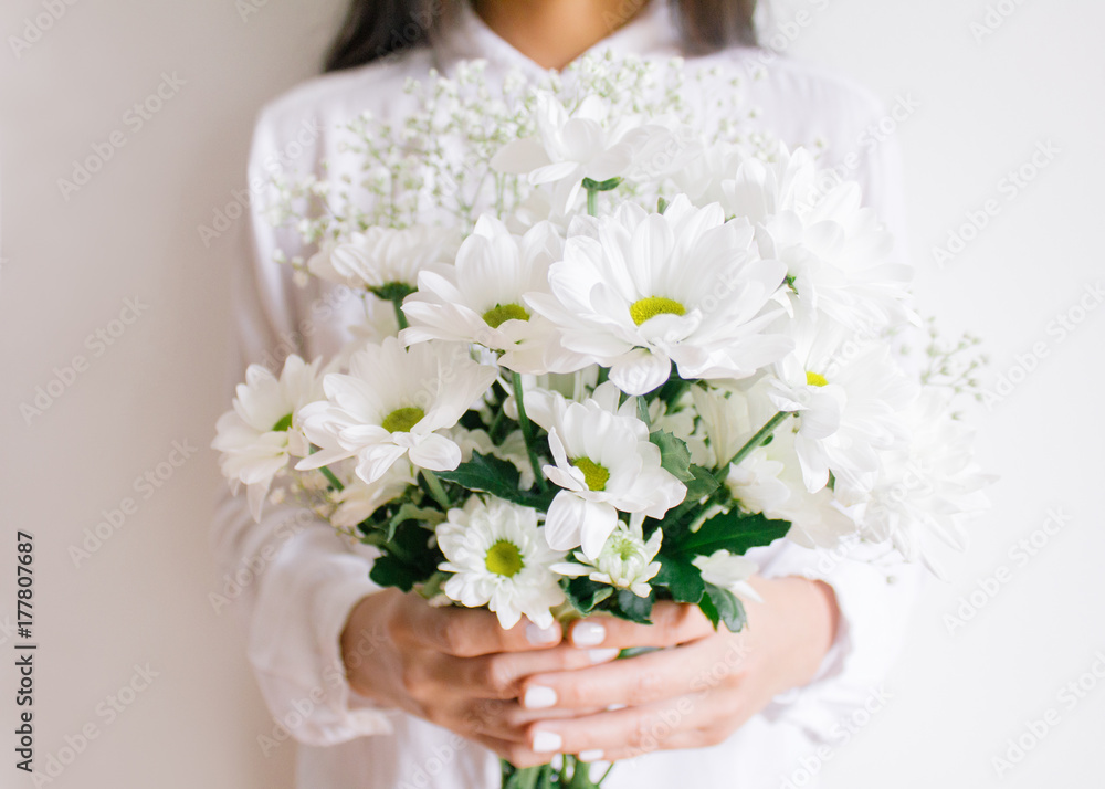 Young woman holding beautiful white flower bouquet Young woman holding beautiful white flower bouquet