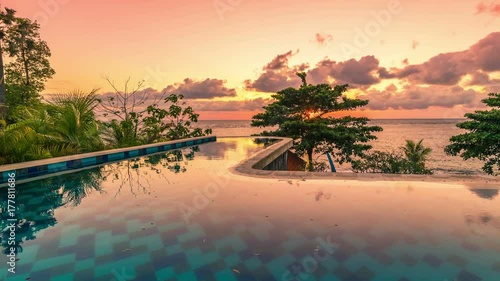 Beautiful tropic timelapse Sunset over infinity Pool in Bali photo
