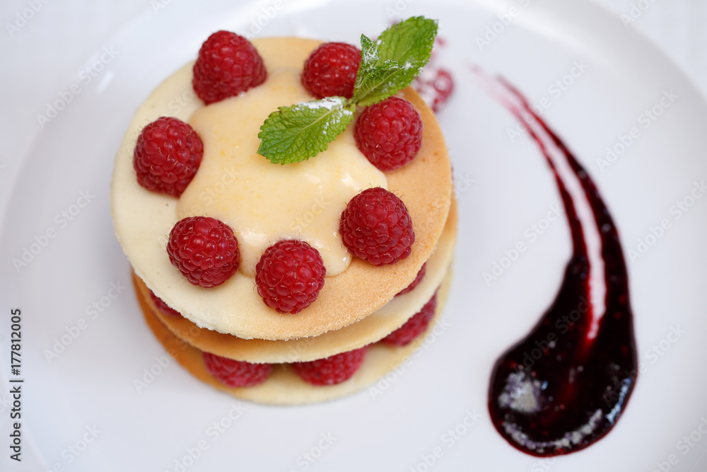 Exquisite dessert with cookies, cream and raspberries Exquisite dessert with cookies, cream and raspberries