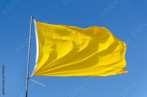 Yellow flag attached to flagpole