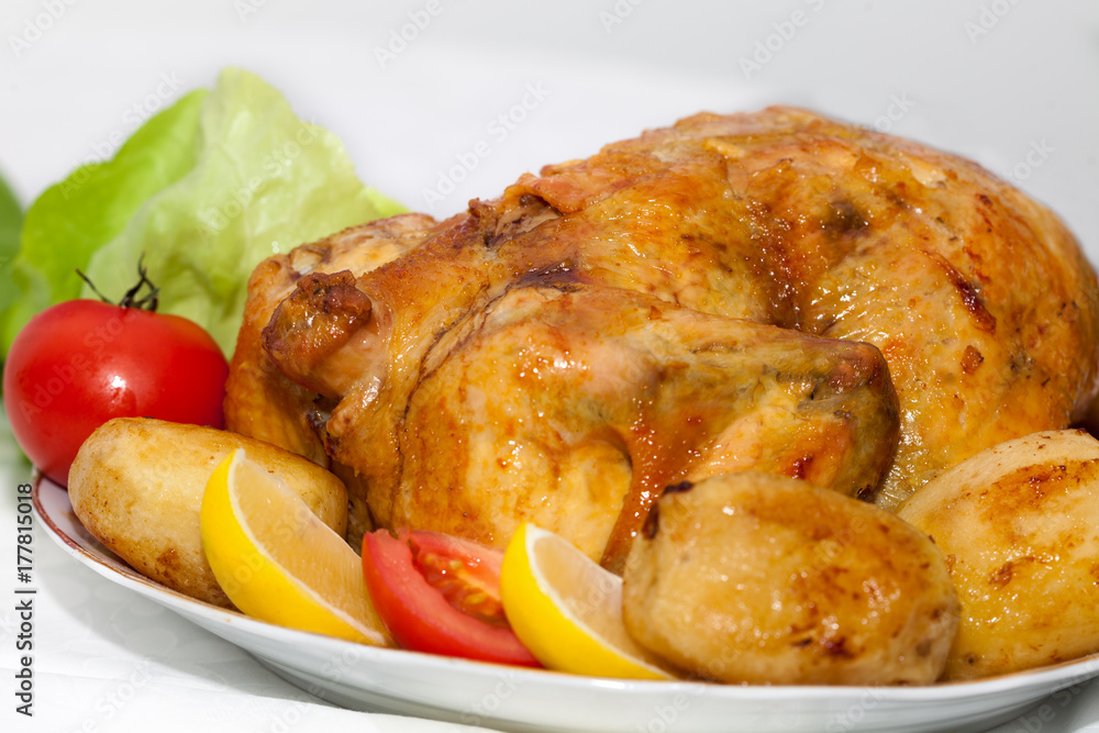 Juicy,crispy roasted chicken for dinner. Chicken with lemon and vegetables. Juicy,crispy roasted chicken for dinner. Chicken with lemon and vegetables.