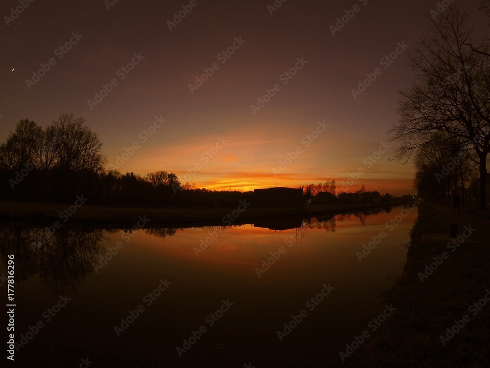 Colorful sky at sunrise reflected in the water of the river Colorful sky at sunrise reflected in the water of the river