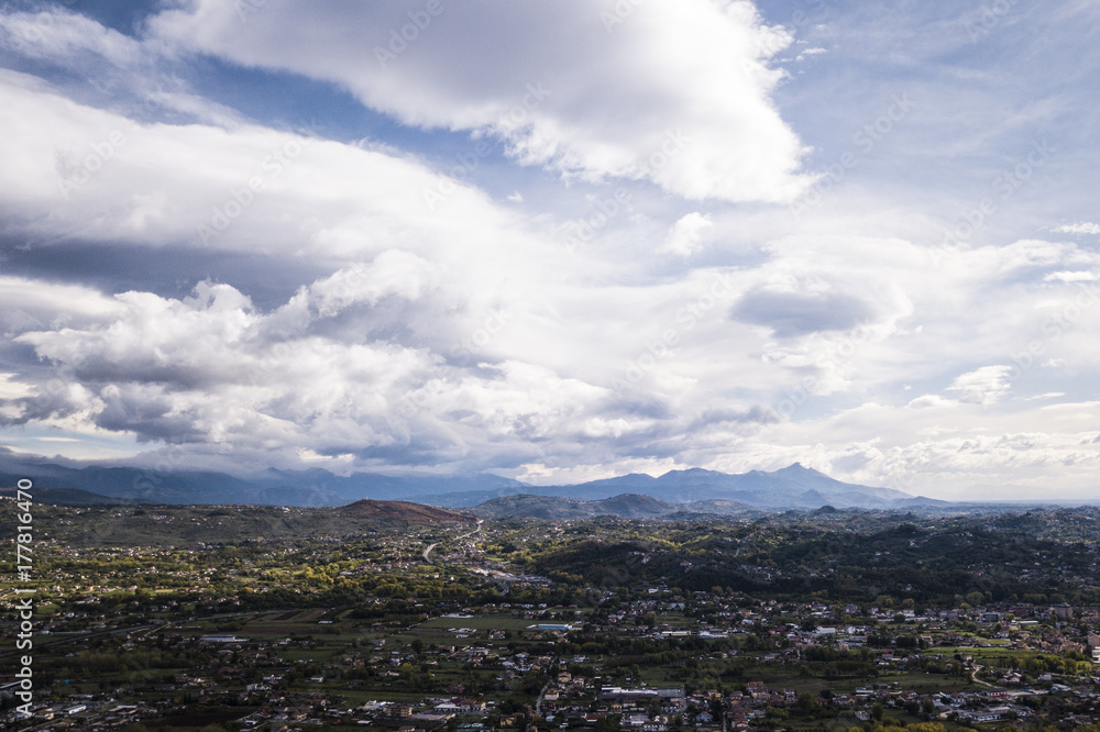 Fototapeta premium Aerial view of an Italian countryside with a dramatic and cloudy sky.