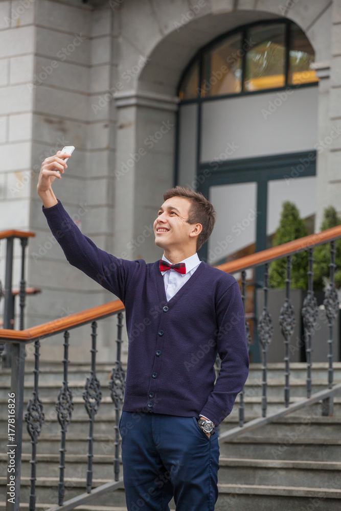 guy in business style clothes on stairway background. Stylish guy. Take pictures of yourself guy in business style clothes on stairway background. Stylish guy. Take pictures of yourself