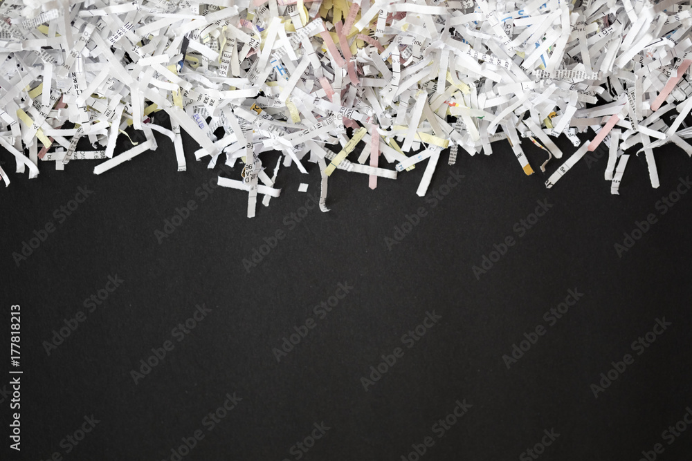 Shredded documents over black background 