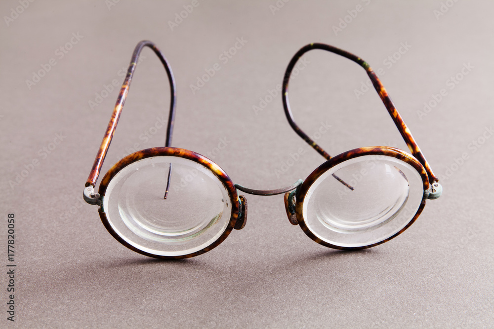 Old fashion design spectacles eyeglasses on gray paper background