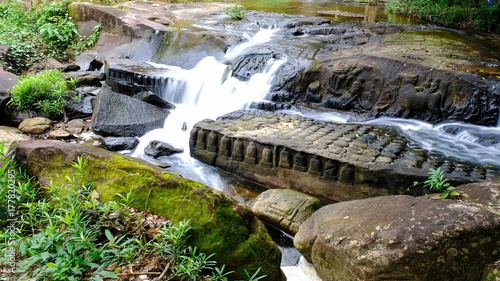 Kbal spean waterfall front view with angkor sculpture and lingas on the sandstone rock, Kulen Hills, the northeast of Angkor, siem Reap, Cambodia photo