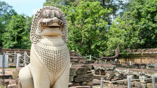 Singha (Lion) statue sit to protect in front of Angkor Thom Temple
