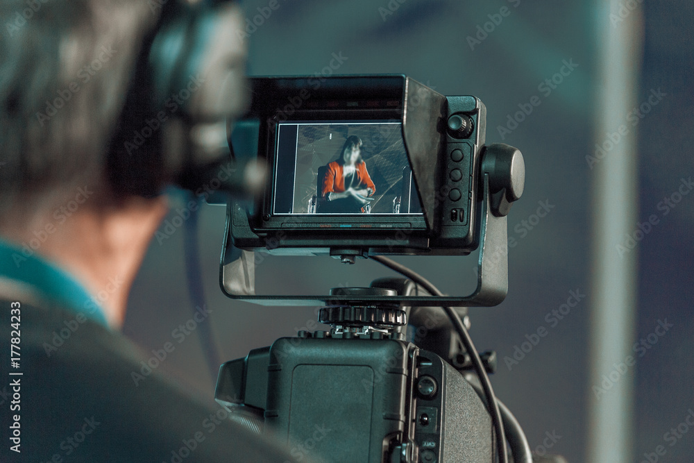 Cameraman shooting in studio close-up Cameraman shooting in studio close-up