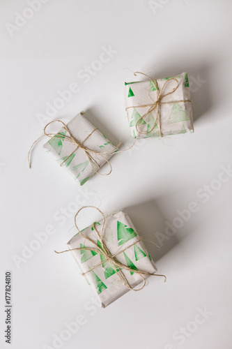 White: Scatterd Christmas Gifts Wrapped In Stamped Paper photo