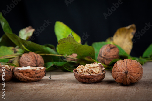 walnuts (Juglans regia) on a black background with leaves from the stoma