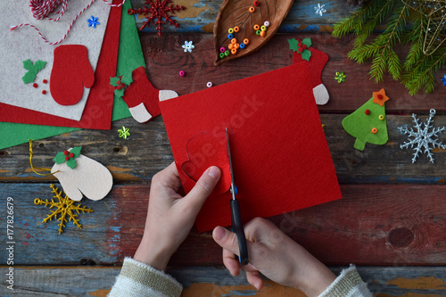 Making of handmade christmas toys from felt with your own hands. Children's DIY concept. Making xmas tree decoration or greeting card. Step 2. Cut the toy